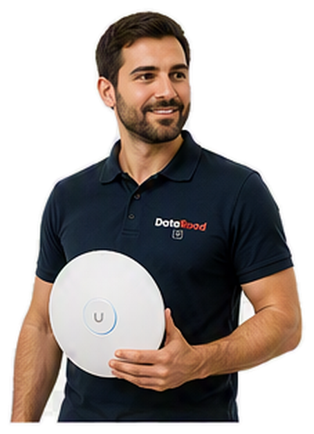 Bearded man in a navy polo shirt holding a round white wireless device with a blue ring and a 'U' button, wearing a DotaRoad logo polo.